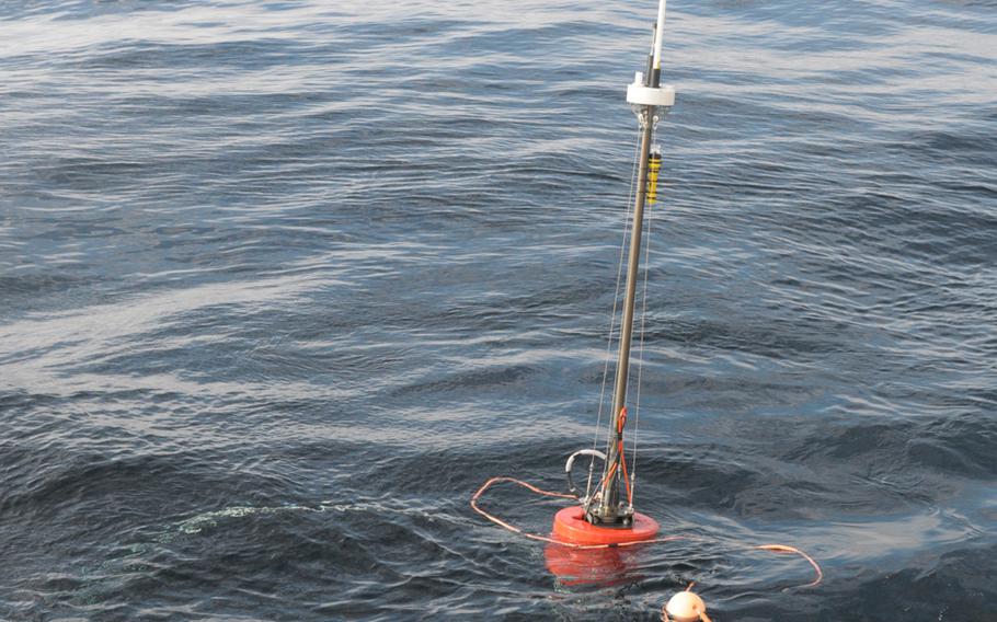A sonar buoy launched by the NATO research ship NRV Alliance extends the reach of an autonomous underwater vehicle, collecting data through an underwater acoustic modem and relaying it to the ship by radio signal. The Alliance is testing the vehicles off the coast of Norway as part of the NATO exercise Dynamic Mongoose in May 2015.