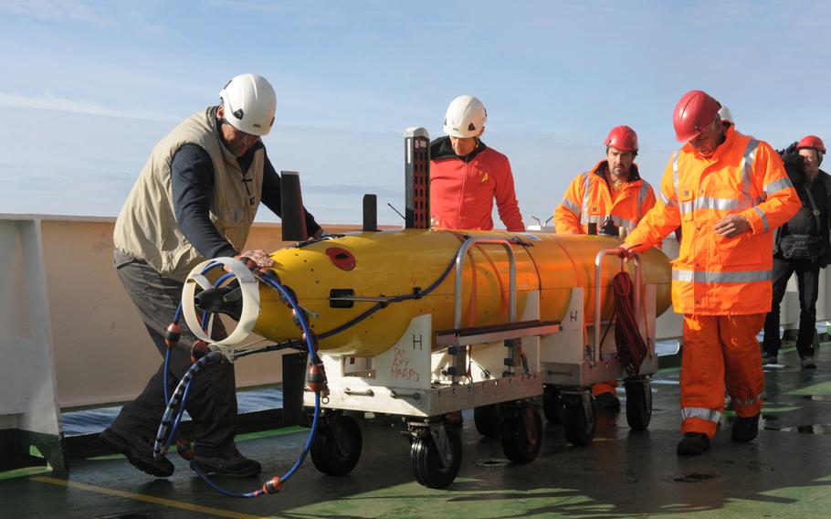 Crew members of the NATO research vessel NRV Alliance prepare to launch the first of two autonomous underwater vehicles in the North Sea off the coast of Norway on May 5, 2015. Programmed to track objects moving underwater, the devices are being tested by NATO's Centre for Maritime Research and Experimentation as part of a NATO anti-submarine warfare exercise, Dynamic Mongoose.