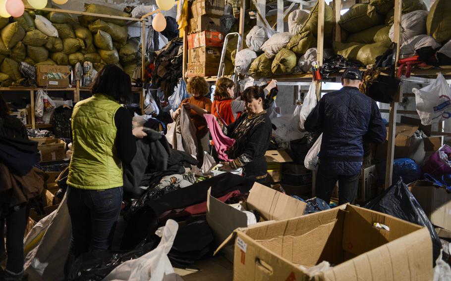 Volunteers at a center for internally displaced persons in Kiev, some of them IDPs themselves, sort through donated clothes.