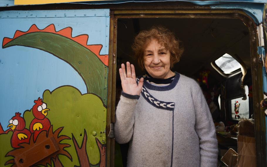 Neal Ivanovna volunteers at a coordination center for internally displaced persons  in Kiev where IDPs can get donated clothing, toys and food. She is in charge of the donated toys inside a colorful, cartoon covered bus.