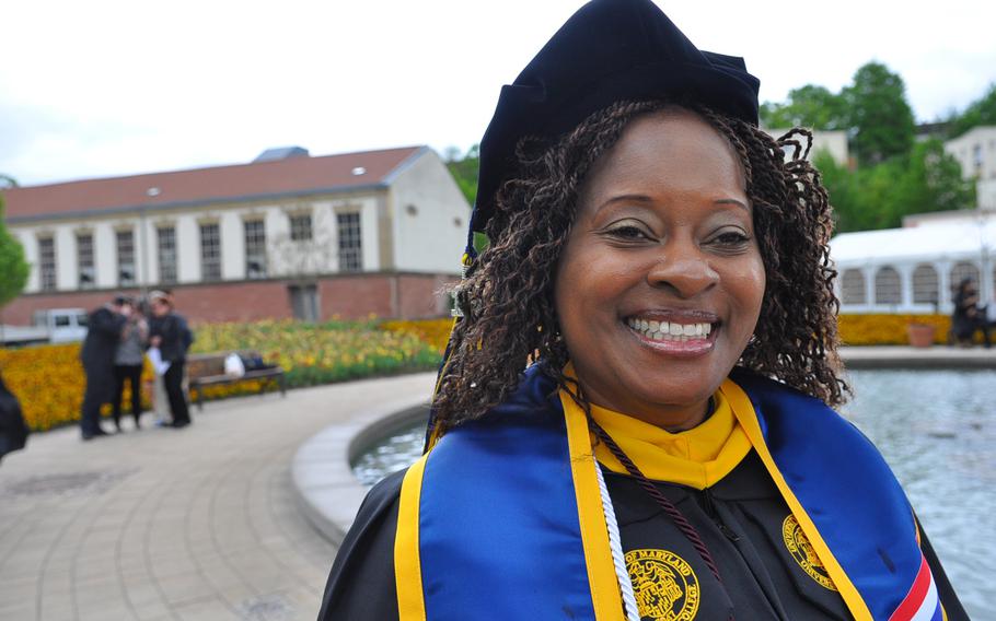 Army Chief Warrant Officer 4 Sonya Howell Barrow, 43, is all smiles before receiving her third college degree on Saturday, May 9, 2015, at the University of Maryland University College Europe commencement. Howell Barrow, who joined the Army when she was 20, juggled college courses with raising two boys as a single parent and deploying four times. She received a master's degree Saturday in cybersecurity and works as an information services technician at Clay Kaserne in Wiesbaden, Germany.