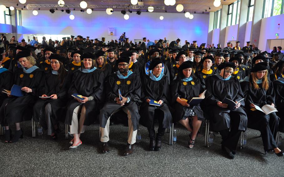 University of Maryland University College Europe graduates sit in the event hall at the Gartenschau in Kaiserslautern waiting for commencement to begin on Saturday, May 9, 2015. The 2015 class comprised more than 1,125 graduates, of which about 250 walked the stage.
