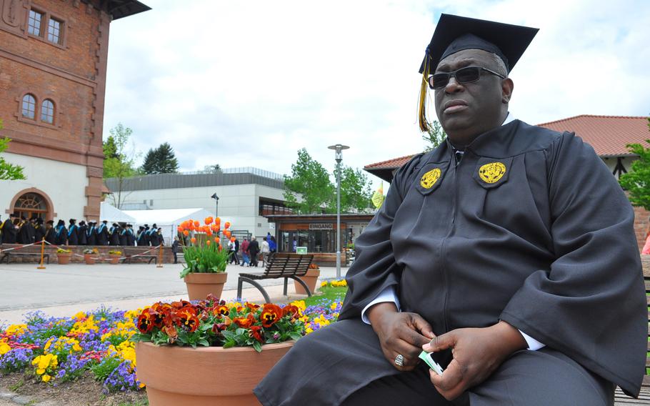 Glynn Beverly, 53, an Army veteran from Ansbach, Germany, waits for commencement exercises to begin at the University of Maryland University College Europe graduation on Saturday, May 9, 2015, at the Gartenschau in Kaiserslautern. He said he didn't mind being the oldest student in his class, since his younger classmates were always willing to help him out.