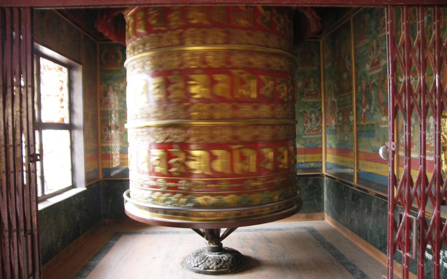 A giant prayer wheel inside a Buddhist temple in Kathmandu, Nepal.