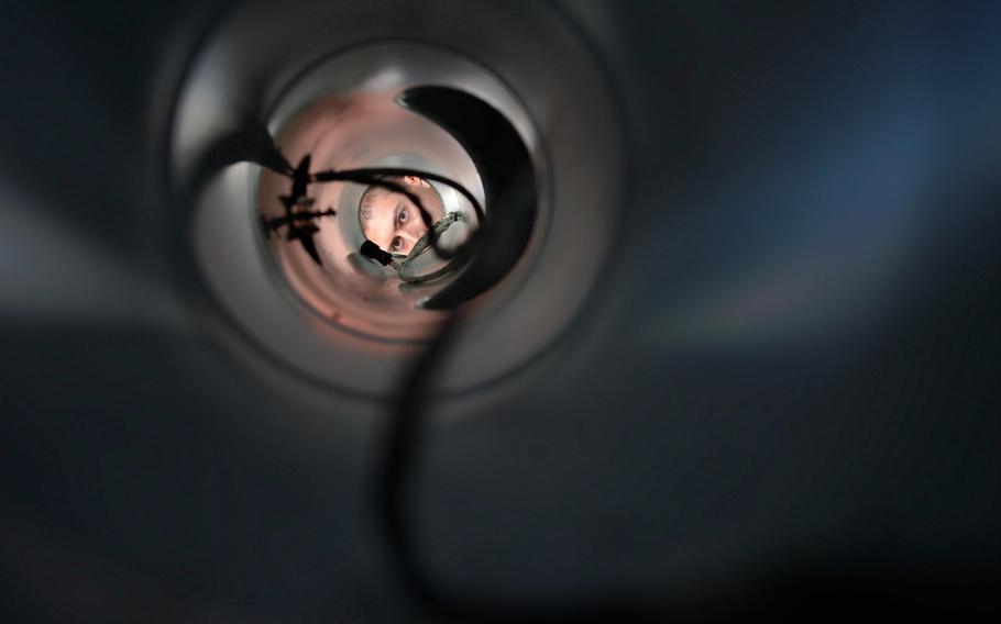 Staff Sgt. Michael Misiewicz, a C-5M Super Galaxy crew chief, visually inspects wheel-speed transducer wiring inside a main landing gear axle of a C-5M during a tire change and brake replacement on April 29, 2015, at Dover Air Force Base, Del.