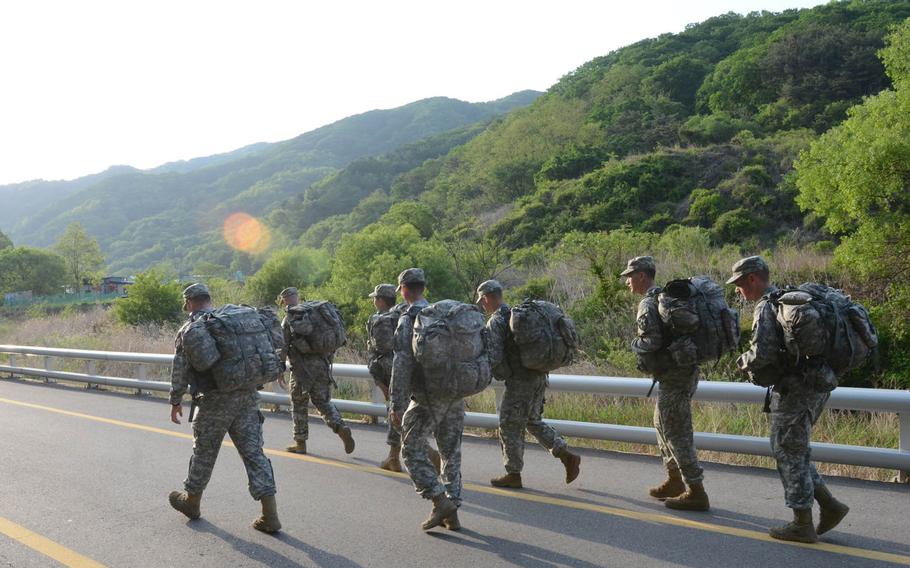 Soldiers from Troop A, 4th Squadron, 7th U.S. Cavalry Regiment, 1st Armored Brigade Combat Team, 2nd Infantry Division, march outside Camp Hovey on Thursday, May 14, 2015, in preparation for the final Manchu Mile in South Korea scheduled for May 20.