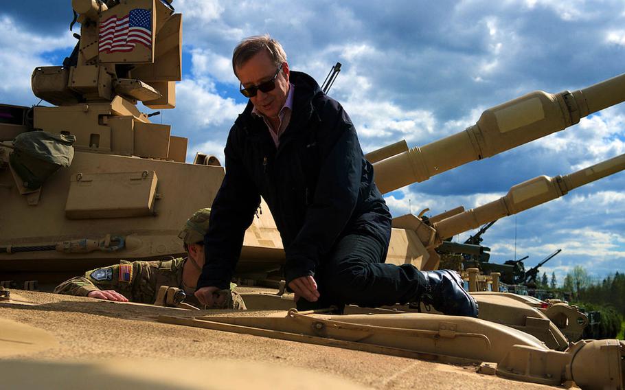 Estonian President Toomas Hendrik Ilves climbs up the hull of an M1A2 Abrams Battle Tank from the 3rd Infantry Division's 2nd Battalion, 7th Infantry Regiment out of Fort Stewart, Ga.,during a visit to Operation Siil held in Johvi, Estonia, May 9, 2015. Soldiers from 3rd Infantry Division and the 173rd Airborne Brigade out of Grafenw??hr, Germany, are currently deployed throughout Europe as part of Operation Atlantic Resolve.