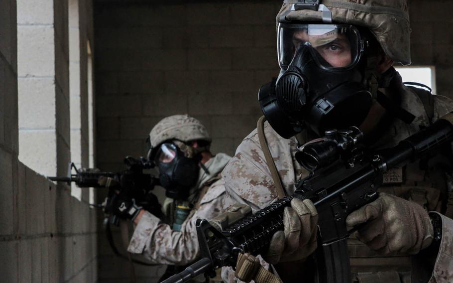 Marines with 1st Battalion, 7th Marine Regiment provide security in a simulated combat town during the culminating event of Division School?s Urban Leaders Course at Camp Pendleton, Calif., April 22, 2015.