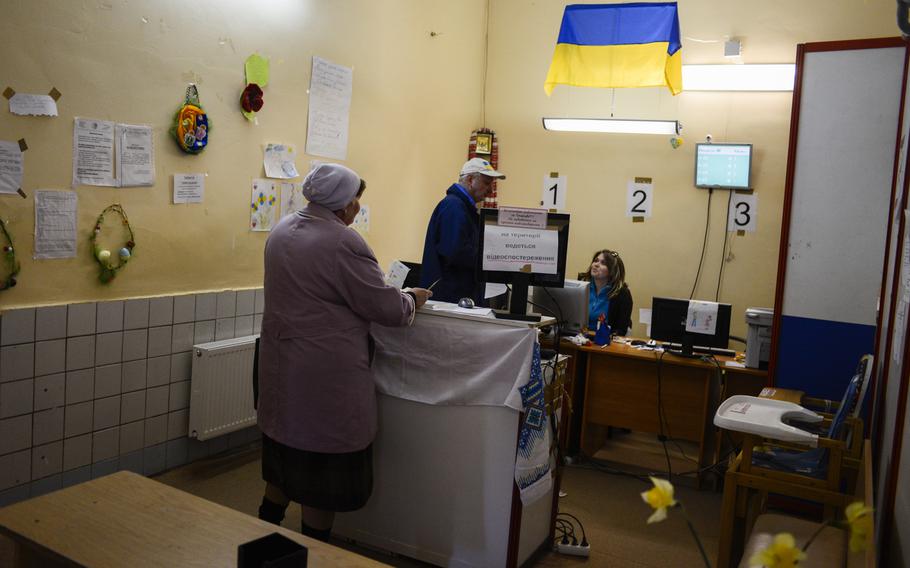 A displaced woman checks in at a center set up to aid people displaced by the war in eastern Ukraine. Depending on her family?s makeup, she will be sent around the complex to pick up food, clothing and other items for which they qualify, Kiev, Ukraine, April 22, 2015.
