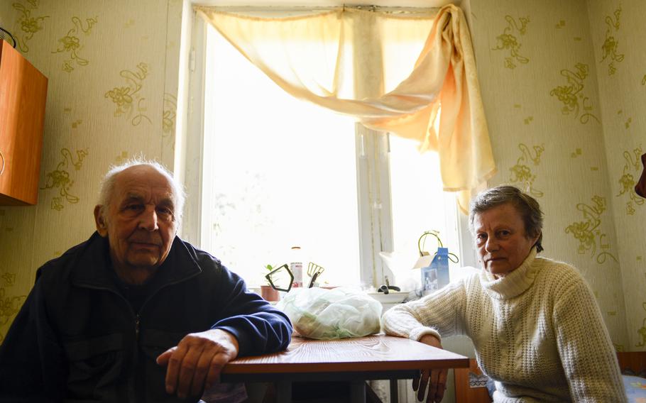 Marina and her husband, Vladimir, pose for a portrait in their tiny, one-room apartment in an abandoned Sanatorium that has been converted into housing for those displaced by the war in eastern Ukraine. The center is in Vorsil, Ukraine, April 23, 2015.