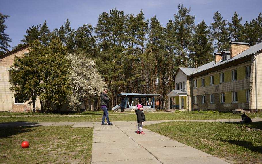 Iryna and her daughter, Victoriya, play outside the converted sanatorium where they live in Vorsil, Ukraine, April 23, 2015. They have been displaced by the war in the country's east.