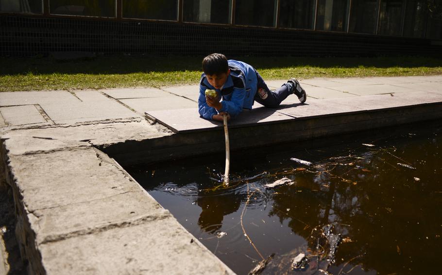 A boy plays outside a sanatorium in Vorsil, Ukraine, that has been converted into housing for refugees from the war in the country's east, April 23, 2015.