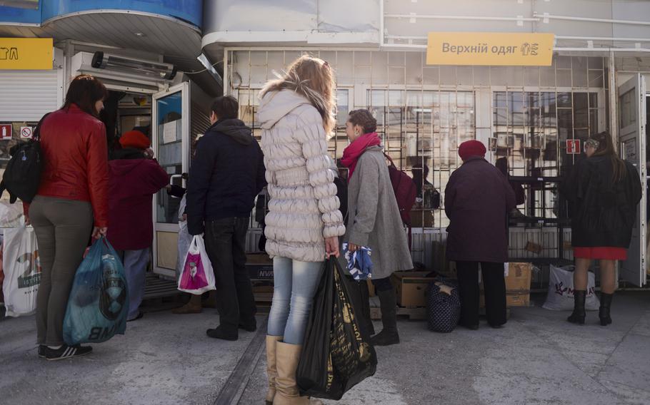 Ukrainians displaced by the war in their country's east pick up food, clothing and other items at a center set up to aid displaced persons in Kievl, April 22, 2015.