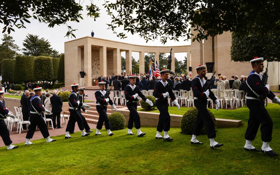 French servicemembers march out at the end of the Memorial Day ceremony at the Normandy American Cemetery, Sunday, May 24, 2015.