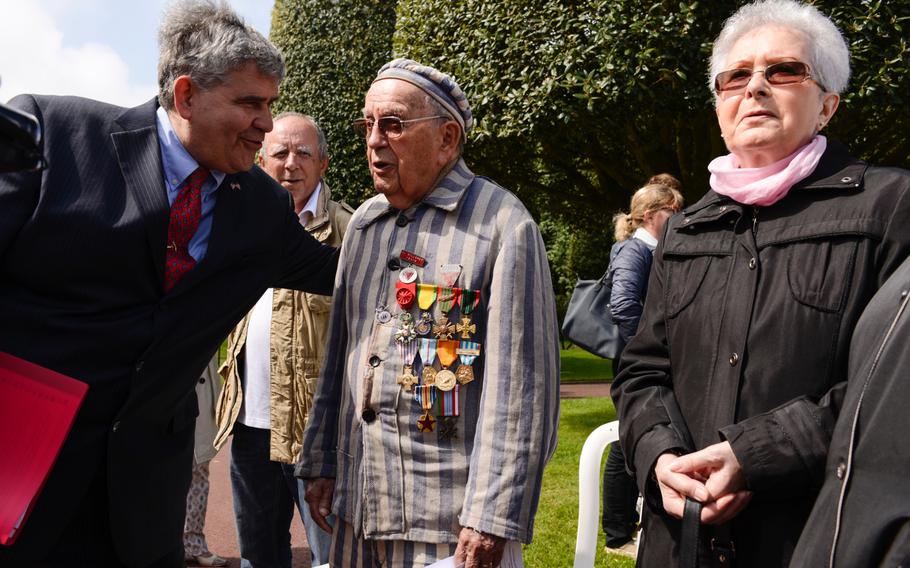 Jean Villeret, 92, speaks with other attendees after the Memorial Day ceremony at the Normandy American Cemetery, Sunday, May 24, 2015. Villeret was a member of the French resistance and spent time in a concentration camp after being captured by the Germans.