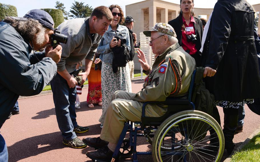 George Shenkle, 93, speaks with Capt. Jed Wentz, left, of the 2nd Cavalry Regimen,t after the Memorial Day ceremony at the Normandy American Cemetery, Sunday, May 24, 2015. Shenkle, a member of the 82nd Airborne Division, jumped into Normandy on D-Day as well as Operation Market Garden before later being wounded in the Ardennes during the Battle of the Bulge.