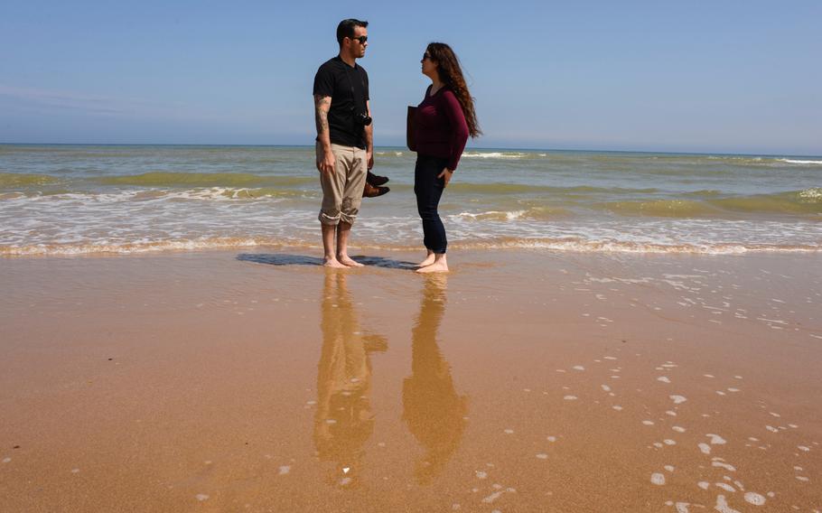Staff Sgt. Brandon and Brittany Fitzgerald reflect on Omaha beach below the Normandy American Cemetery after the Memorial Day ceremony, Sunday, May 24, 2015.