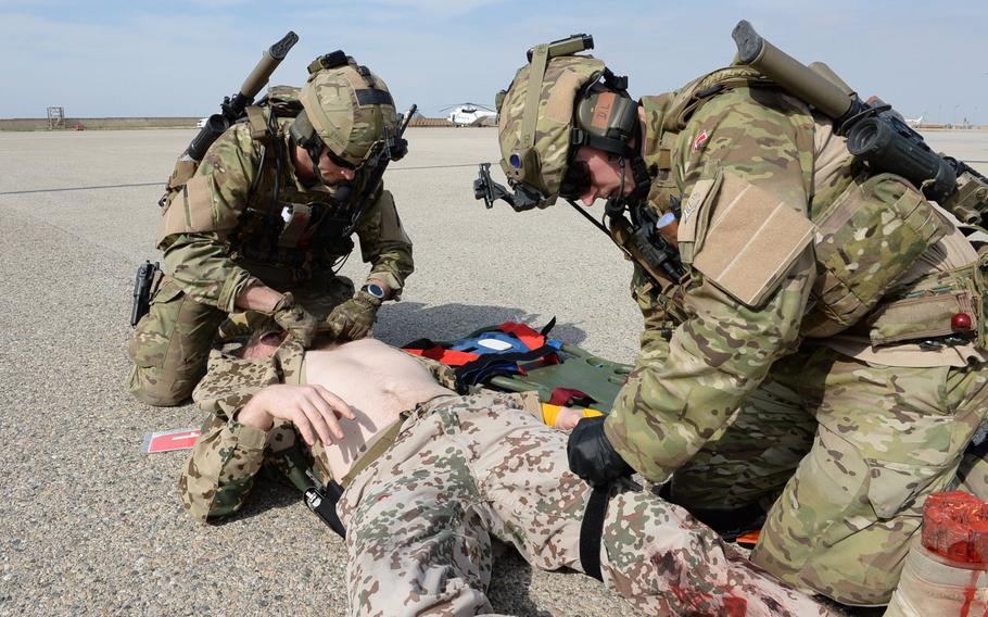 Danish Troops at Train, Advise and Assist Command-North in Afghanistan prepare a mock casualty during a medical evacuation drill at the command's headquarters in Mazar-e-Sharif.