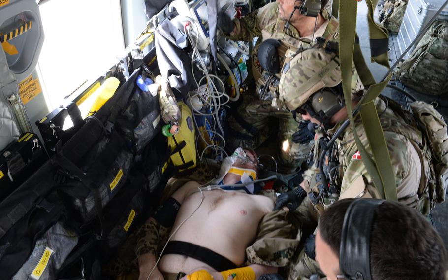NATO troops treat a simulated casualty during a medical evacuation drill in Mazar-e-Sharif. U.S. and NATO forces have stepped up combat drills at Train, Advise and Assist Command-North, in preparation for the spring fighting season.
