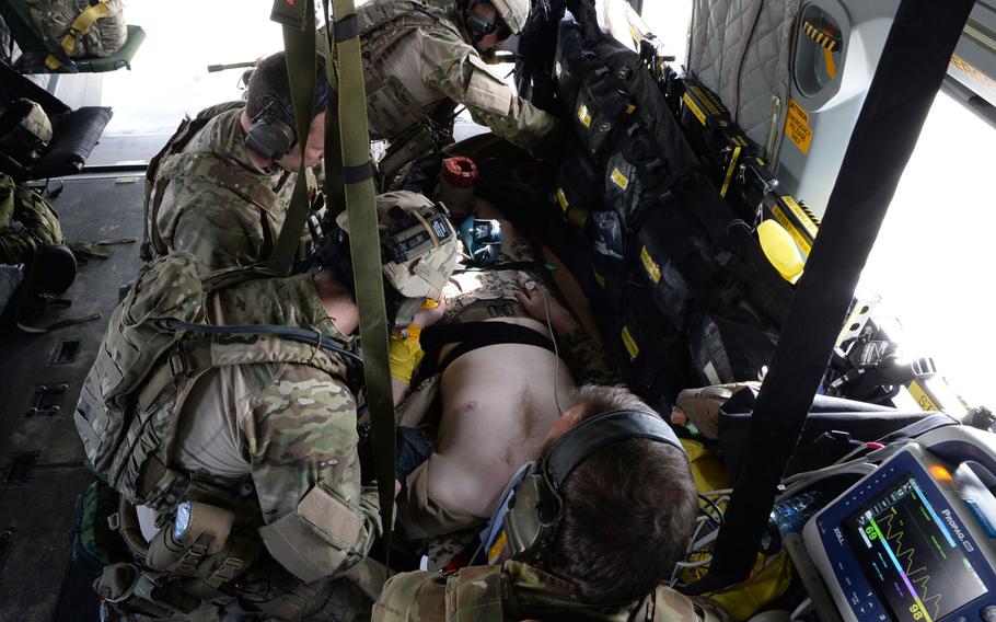 A mock casualty is stabilized by NATO medics during a medical evacuation drill at Train, Advise and Assist Command-North. The drill was part of the command's preparations for the upcoming spring fighting season in Afghanistan.