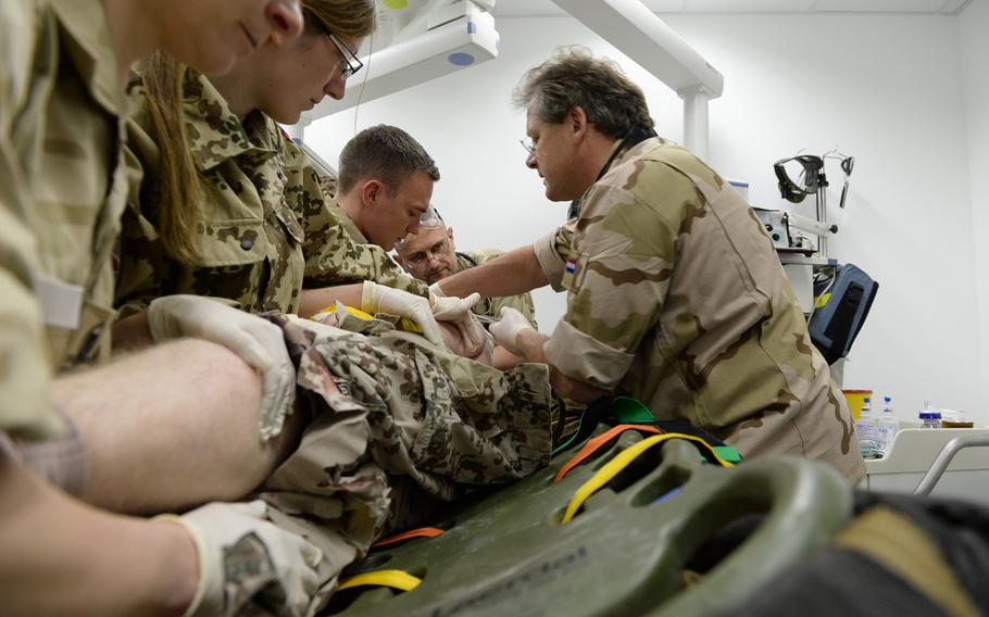 NATO doctors at the German military hospital in Mazar-e-Sharif, Afghanistan, move a simulated casualty for surgery on March 31, 2015. The drill was part of a series of exercises U.S. and NATO forces conducted at Train, Advise and Assist Command-North in preparation for the spring fighting season.