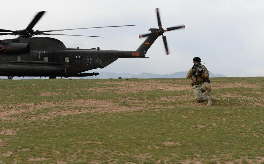 A Georgian soldier provides cover to members of TAAC-North's Quick Reaction Force during a March 31, 2015, air-assault drill in northern Afghanistan. U.S. and NATO forces are preparing for the spring fighting season in the country.