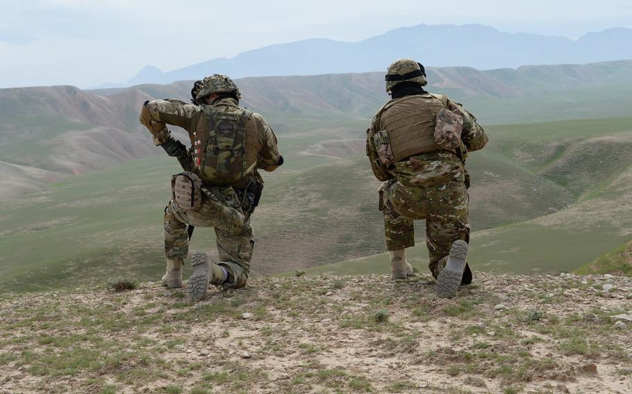 Two members of TAAC-North's Quick Reaction Force keep their eyes and weapons fixed on the horizon during a combat assault drill in Balkh province on March 31, 2015. The drills were part of the command's preparations for the upcoming spring fighting season in Afghanistan.
