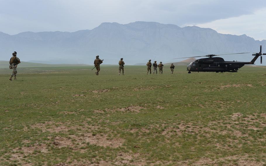 Georgian troops assigned to the quick-reaction force at Train, Advise and Assist Command-North file toward an awaiting German helicopter, during a March 31, 2015, air-assault drill in Afghanistan's Balkh province.