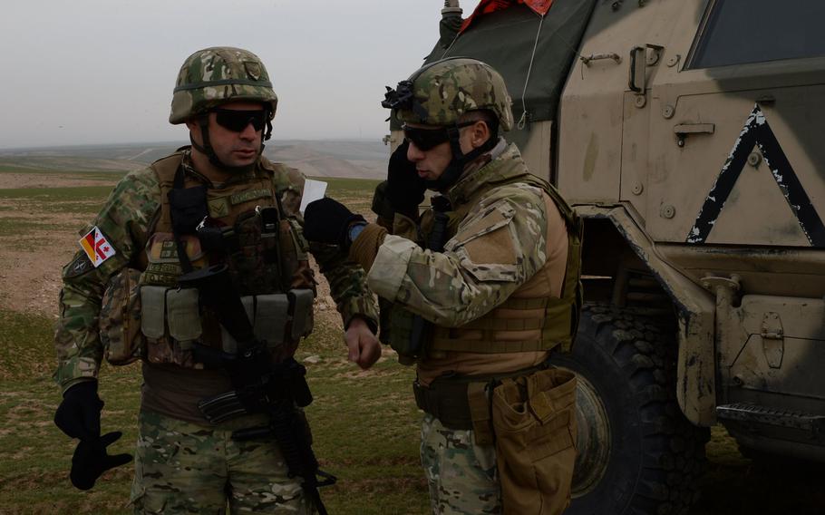 The Georgian platoon leader for the quick-reaction Force at Train, Advise and Assist Command-North calls in coordinates to German helicopter pilots during a March 31, 2015, air-assault drill in Balkh province, northern Afghanistan.
