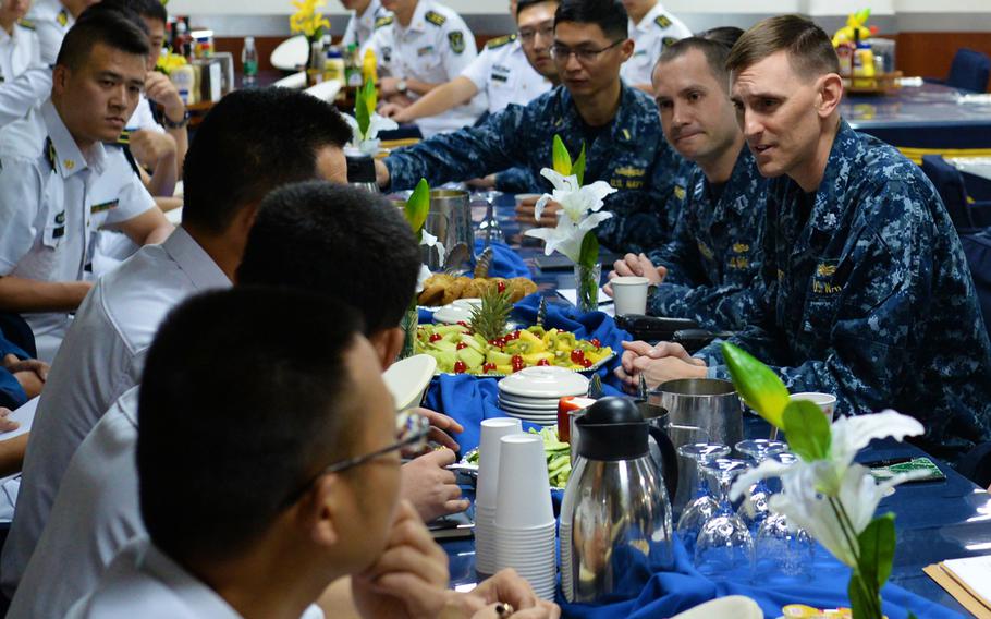 Cmdr. Nathan Fugate, right, executive officer of the U.S. 7th Fleet flagship USS Blue Ridge, plans a search-and-rescue exercise with Chinese naval officers aboard the ship while visiting Zhanjiang, China, on April 22, 2015. Researchers at the Shangri-La Dialogue security summit on Friday said that the U.S. and Chinese militaries may find converging interests when it comes to rescuing civilians in hostile regions of the world.