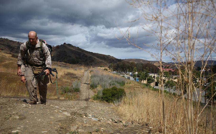 Master Sgt. Vincent Marzi, the operations chief for 1st Force Reconnaissance Company, takes his final steps as he approaches the end of the 7th Annual Recon Challenge aboard Marine Corps Base Camp Pendleton, California, May 15, 2015. After more than 12 hours of events and hiking with a pack, Marzi knew he made Maj. Jeremy Graczyk, a former platoon commander and fallen Marine, proud.