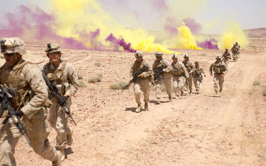 U.S. Marines from Easy Company, 2nd Battalion, 2nd Marine Regiment, charge through clouds of smoke during their last live-fire event of Eager Lion 15 around Al Quweyrah, Jordan, May 19, 2015.