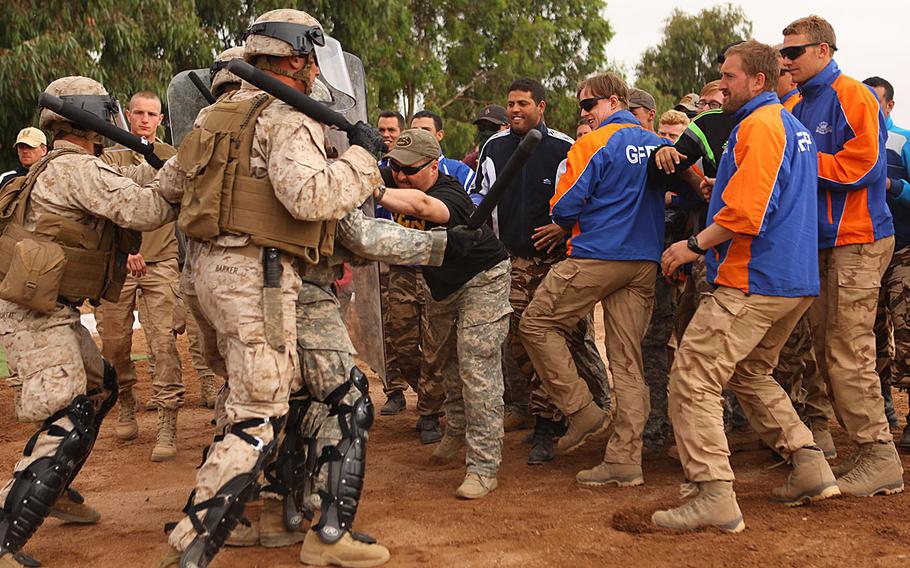 Marines with 2nd Law Enforcement Battalion demonstrate crowd control procedures against group of Moroccan, Dutch and Belgium soldiers acting as an unruly crowd May 20 in the Tifnit, Morocco, training area.