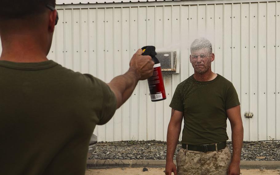 U.S. Marine Cpl. Lacy Martinson, a combat engineer with the Logistics Combat Element, Special Purpose Marine Air Ground Task Force???Crisis Response???Central Command, is sprayed during the Oleoresin Capsicum (OC spray) portion of the Nonlethal Weapons Course conducted by the Law Enforcement Detachment for Marines from the Logistics Combat Element and the Ground Combat Element in an undisclosed location within the Central Command Area of Operations, May 26, 2015.