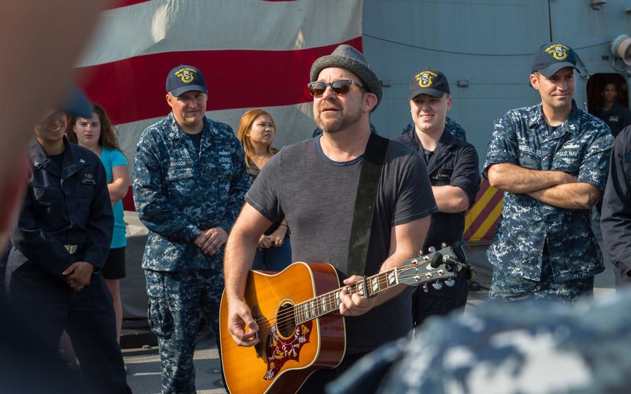 Kristian Bush, a member of the band Sugarland, performs for sailors aboard the fUSS McCampbell at Yokosuka Naval Base, Japan.