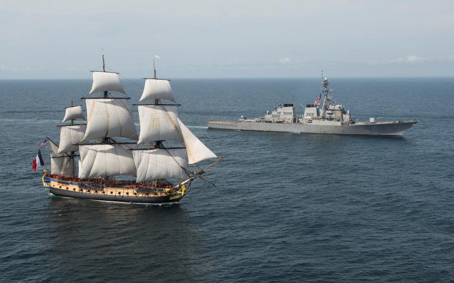 The USS Mitscher, right, provides a warm welcome to the French tall ship replica the Hermione in the vicinity of the Battle of Virginia Capes off the East Coast of the United States on June 2, 2015. The original Hermione brought French General Marquis de Lafayette to America in 1780 to inform General Washington of France's alliance and impending support of the American Revolutionary War.