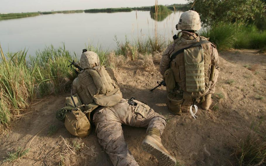 In this combat camera image, U.S. Marines with Alpha Company, 1st Battalion, 7th Marine Regiment provide security near Saqlawiyah, Iraq, June 3, 2009. Combat camera photographers constantly deploy with combat units to document the work of U.S. troops.

