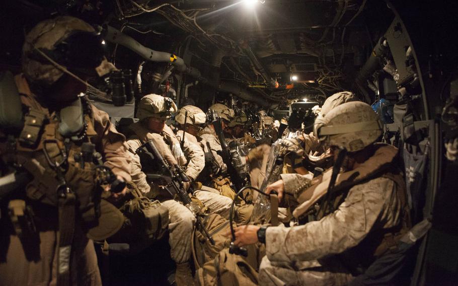 In this combat camera image, a quick reaction force with Special-Purpose Marine Air-Ground Task Force Crisis Response prepares to depart Naval Air Station Sigonella, Italy, in support of a military assisted departure from the U.S. Embassy in Tripoli, Libya, Saturday, July 26, 2014.   