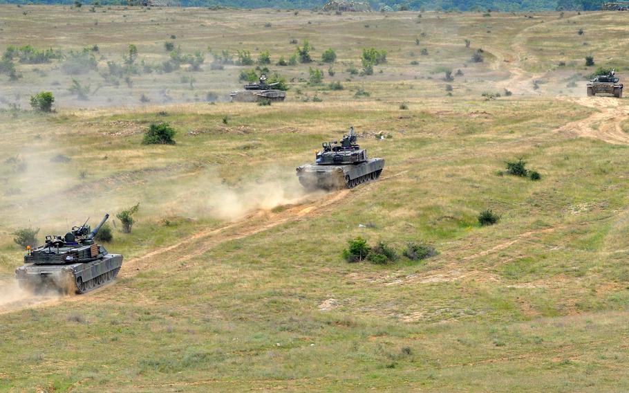 Two American M1A2 and two Bulgarian T-72 tanks rumble across the Novo Selo Training Area in Bulgaria during a live-fire exercise, June 25, 2015. Soldiers from 3rd Infantry Division are also set to arrive at the base this fall for a 90-day rotation.