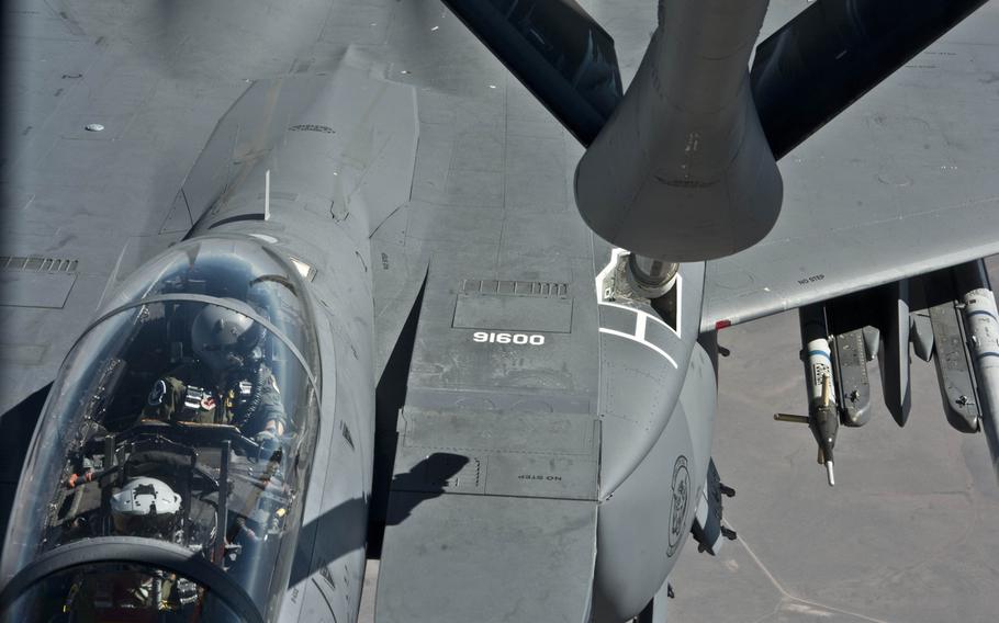 A pilot flying a F-15E Strike Eagle from Mountain Home Air Force Base, Idaho, looks over as a KC-135 Stratotaker from Fairchild AFB, Wash., prepares to refuel it during a mission on  June 25, 2015, over the Inland Northwest.