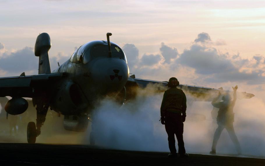 An EA-6B Prowler, attached to the ''Yellow Jackets'' of Electronic Attack Squadron 138, is directed onto the catapult as it prepares to launch off the flight deck of Nimitz-class aircraft carrier USS John C. Stennis on July 25, 2007.