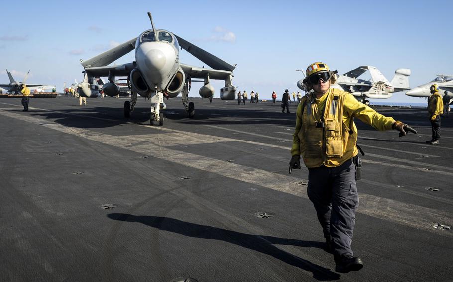 Aviation Boatswain?s Mate 1st Class Anthony White directs an EA-6B Prowler assigned to the ''Gray Wolves'' of Electronic Attack Squadron 142 across the flight deck of the aircraft carrier USS Nimitz on Ocbober 26, 2013.