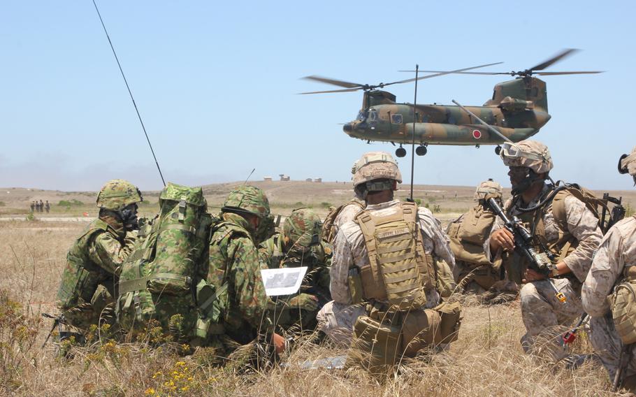 U.S. Marines and Japanese Self-Defense Force soldiers go over maneuver tactics while conducting amphibious assault operations on San Clemente Island on June 17, 2013. Japanese Prime Minister Shinzo Abe has been pushing for ''collective self defense,'' which would allow his country's military to defend its allies in the event of an attack.