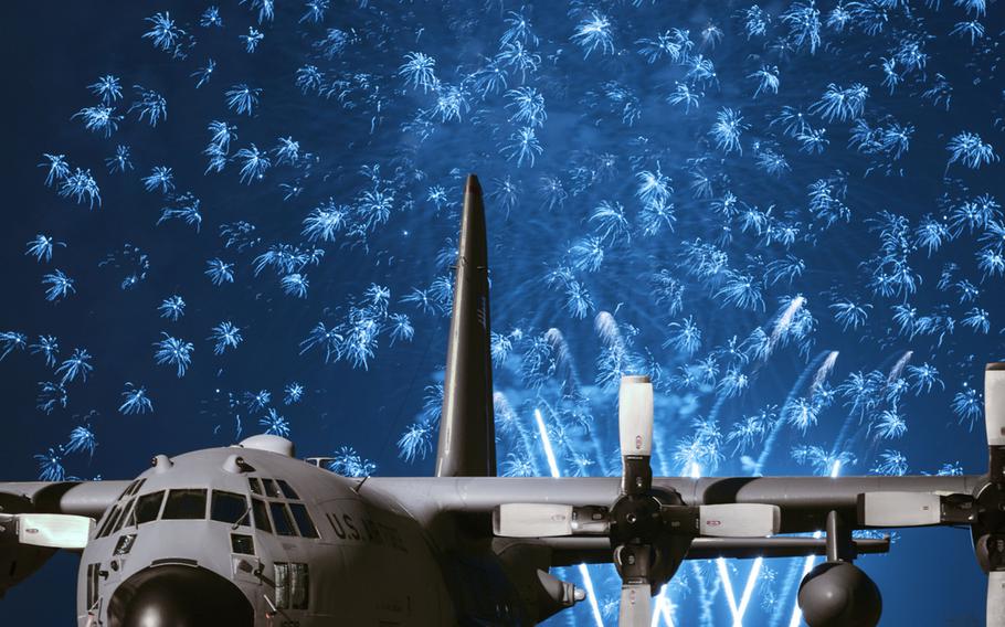 Fireworks explode behind a C-130 Hercules during Celebrate America on Thursday, July 2, 2015, at Yokota Air Base, Japan.