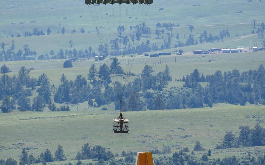 An aircrew assigned to the 153rd Airlift Wing, Wyoming Air National Guard drops a Container Delivery System bundle from a C-130H Hercules aircraft from about 5,000 feet above ground during Joint Precision Airdrop Delivery System training on Saturday, June 27, 2015, at the North Training Area, Camp Guernsey Joint Training Center, Wyo.
