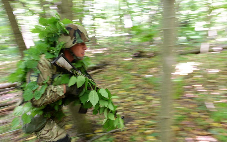 A Ukrainian national guardsman, wearing camouflage, reacts to a simulated attack July 9, 2015, at a training facility in Yavoriv, Ukraine. Because of its fight against Russian-backed separatists, Ukrainian forces have more recently used conventional warfare tactics than the U.S. soldiers sent here to train with them.