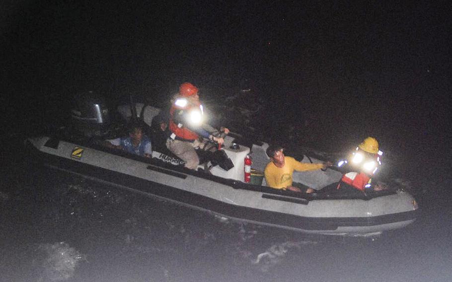 Sailors and personnel from the Military Sealift Command assigned to USNS Impeccable rescue Filipino fishermen from their sinking fishing vessel with a rigid hull inflatable boat on July 19, 2015.