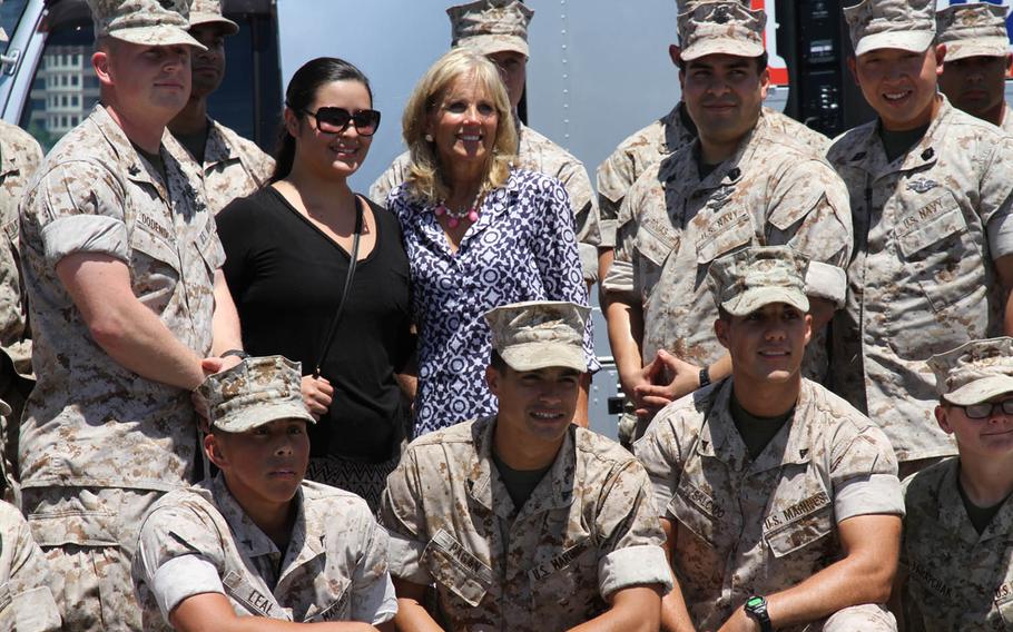 Jill Biden, wife of Vice President Joe Biden, center, poses for a photo with Marines from the III Marine Expeditionary Force at Kadena Air Base in Okinawa, Japan, Thursday, July 23, 2015. Biden stopped in Japan to participate in events tied to her and first lady Michelle Obama's Joining Forces initiative to support servicemembers, veterans and their families after traveling to South Korea, Vietnam and Laos to promote economic empowerment and educational opportunities for women and girls.