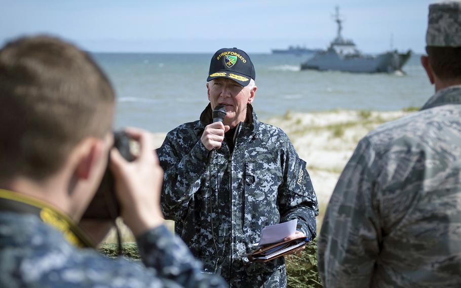 Vice Adm. James Foggo III, commander U.S. 6th Fleet and Naval Striking and Support Forces NATO, center, narrates to a group of NATO officers and leaders involved with exercise BALTOPS 2015, during an amphibious landing at the Ustka Training Range, Poland, June 17, 2015.