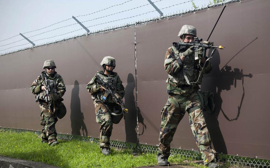 Airmen from the 8th Security Forces Squadron conduct perimeter security following a simulated ground attack during Exercise Beverly Midnight 15-4 at Kunsan Air Base, Republic of Korea, on Thursday, July 16, 2015. Airmen reacted, survived and operated in a simulated combat zone.